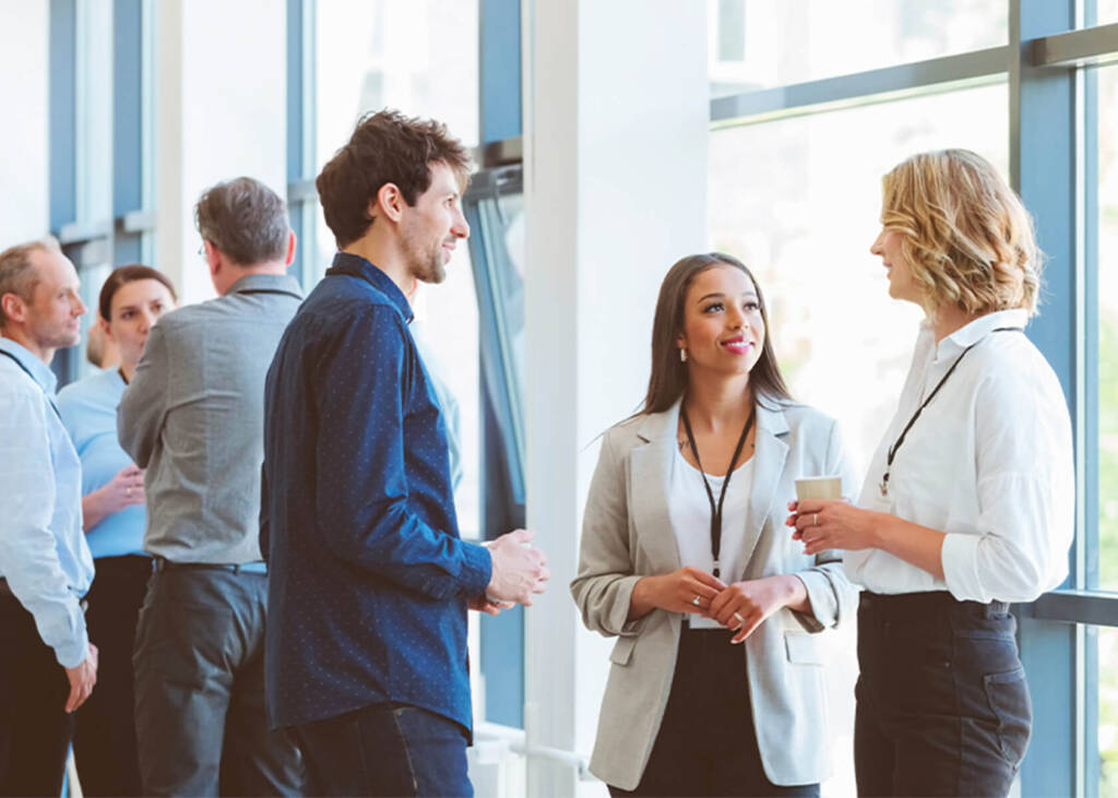 People speaking together at a work event